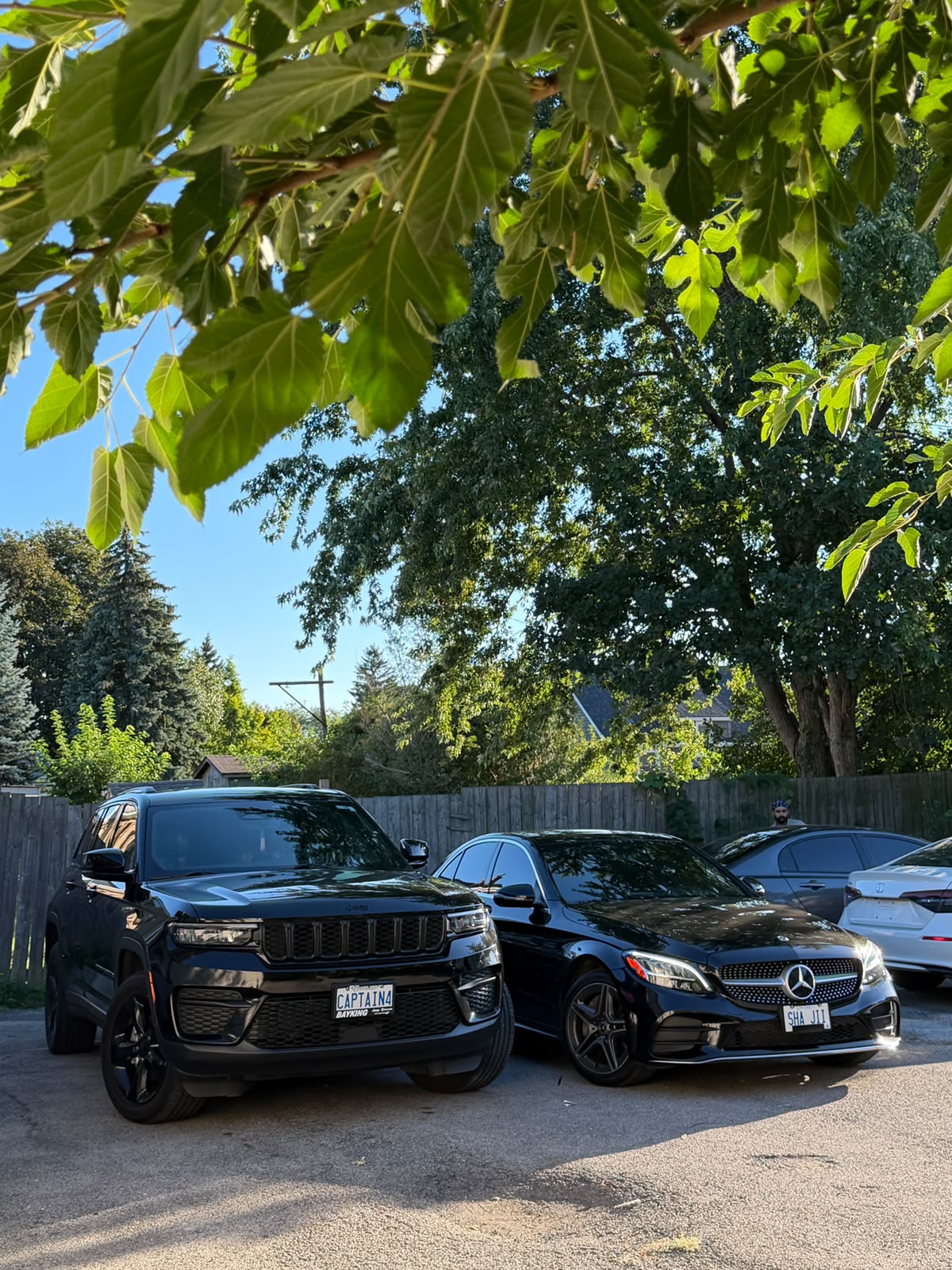Jeep Grand Cherokee and Mercedes-Benz sedan with tinted glass