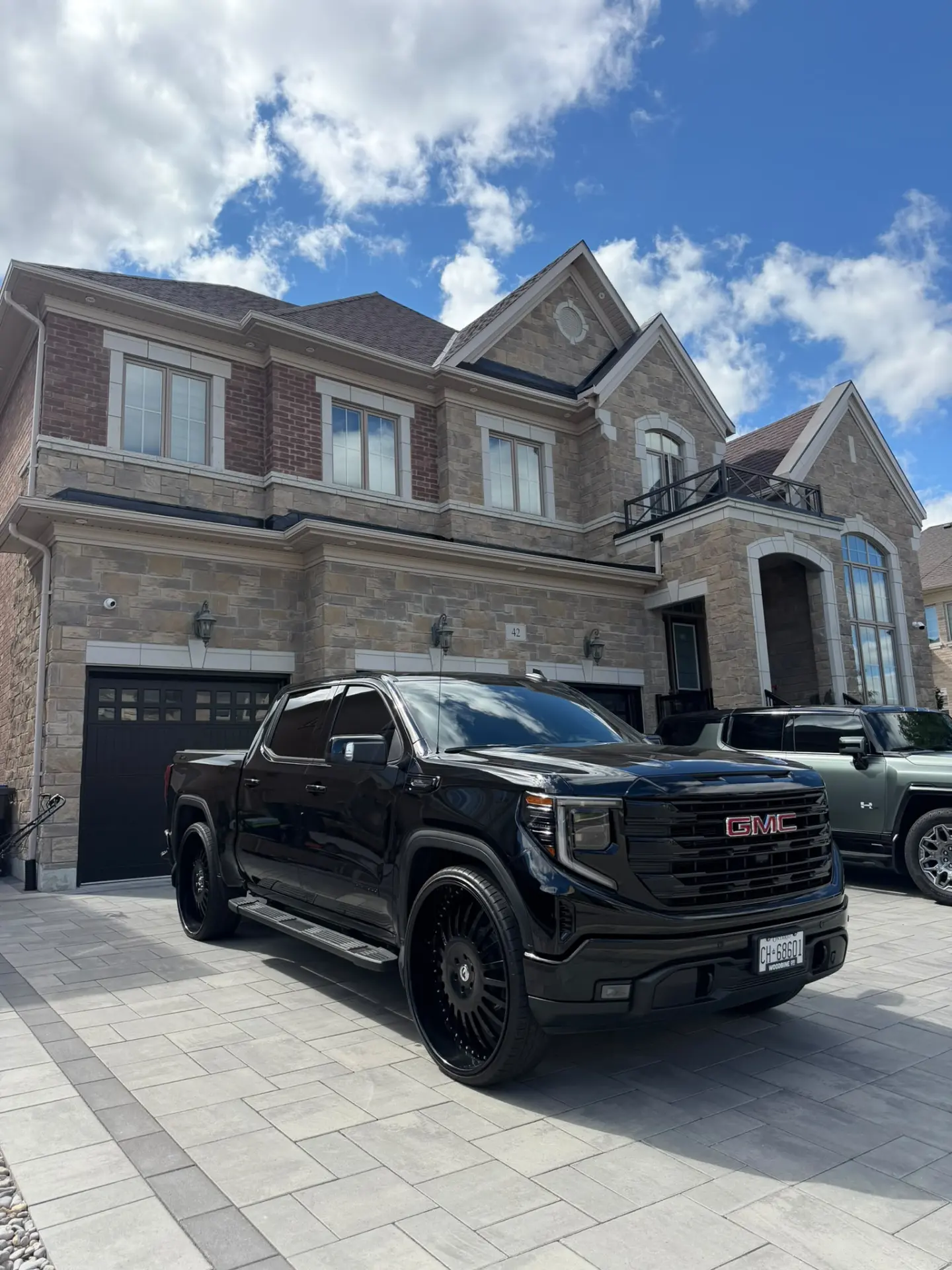 Bachelor Tint mobile service — blacked-out truck detailed in a customer driveway